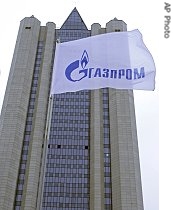 Russia's natural gas monopoly Gazprom headquarters with a flag showing the company's logo on the foreground seen in Moscow, Sunday, Jan. 1, 2006