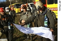 Ukrainian Emergencies Ministry rescuers prepare go to the entrance of the Zasyadka mine in Donetsk, Ukraine, Sunday, 18 Nov. 2007